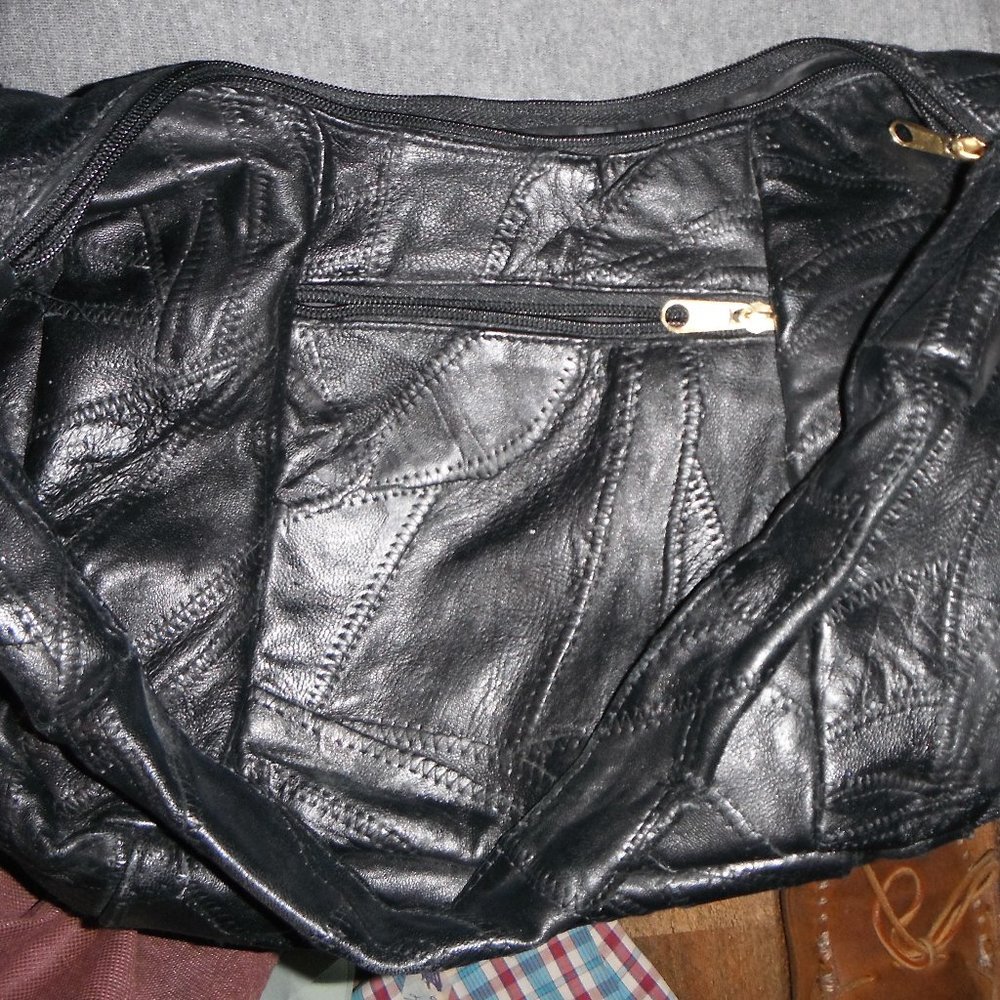 Black leather patchwork shoulder bag, 16" X 11" X 5.5", small tear on handle